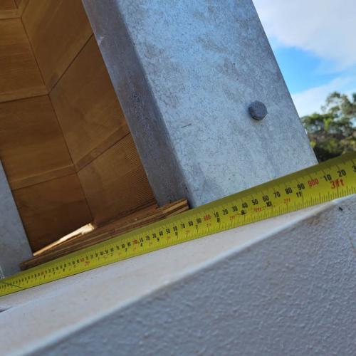 Confirming final measurements with tape measure