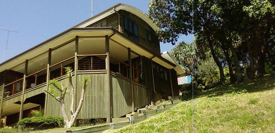 Large elevated three-storey timber house on a steep sloping block, surveyed for building height certification and compliance measurement