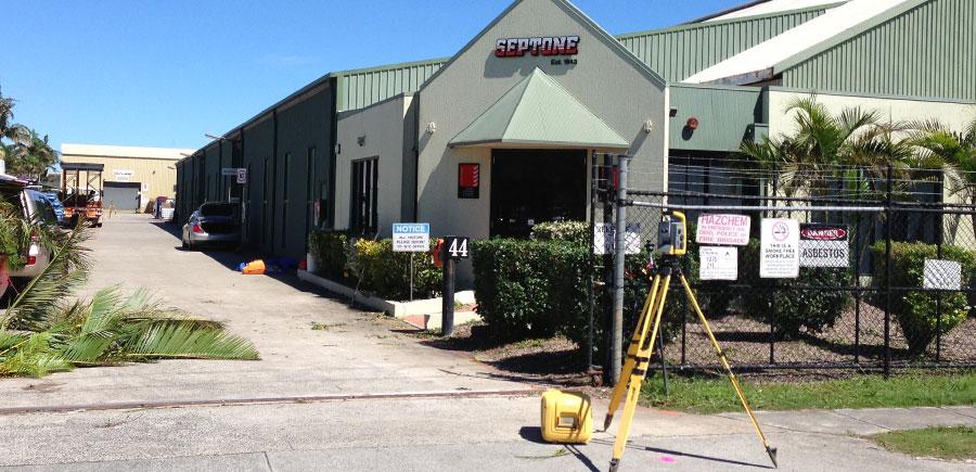 Total station set up on footpath outside Septone commercial premises, capturing measurements for lease survey and tenancy boundary documentation.