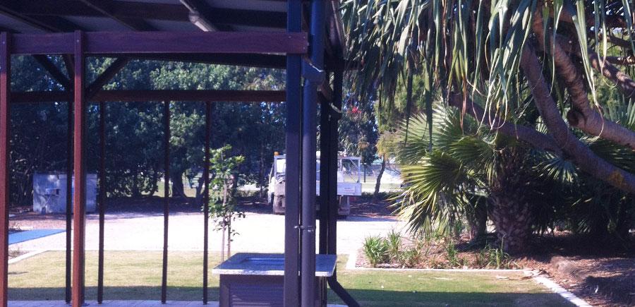 Public park BBQ shelter structure in Redlands, showing built pergola, paved area and surrounding landscaping, used for location certification and surveying compliance