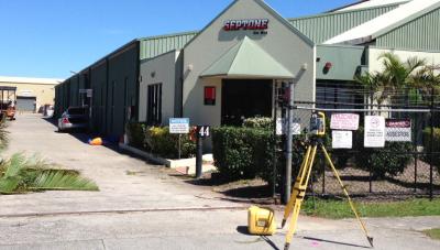 Total station set up on footpath outside Septone commercial premises, capturing measurements for lease survey and tenancy boundary documentation.