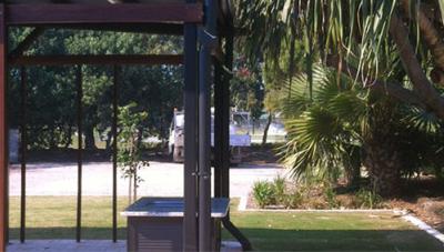 Public park BBQ shelter structure in Redlands, showing built pergola, paved area and surrounding landscaping, used for location certification and surveying compliance